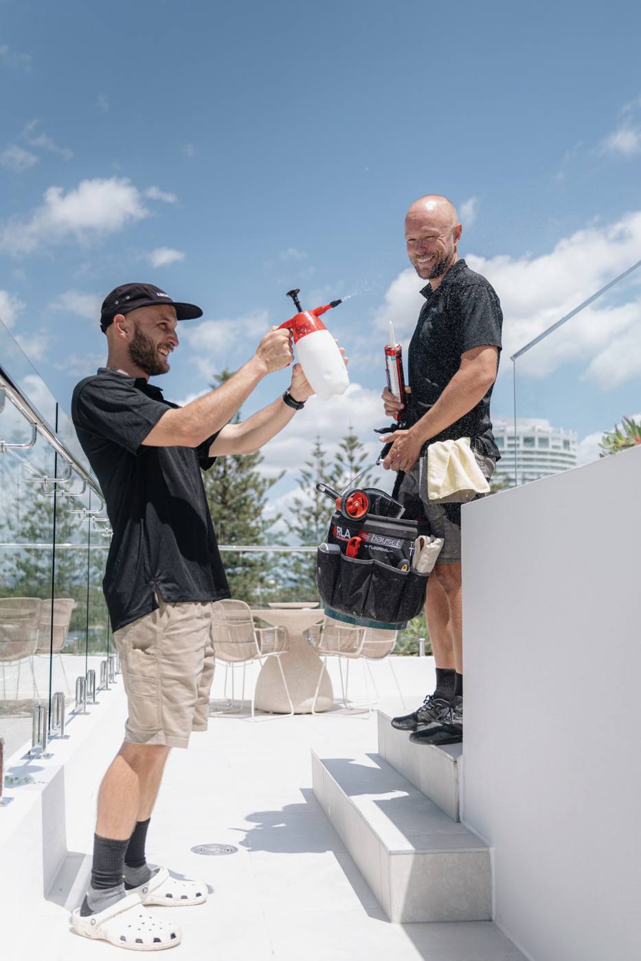 ARCHISEAL crew having a laugh while working on a rooftop terrace