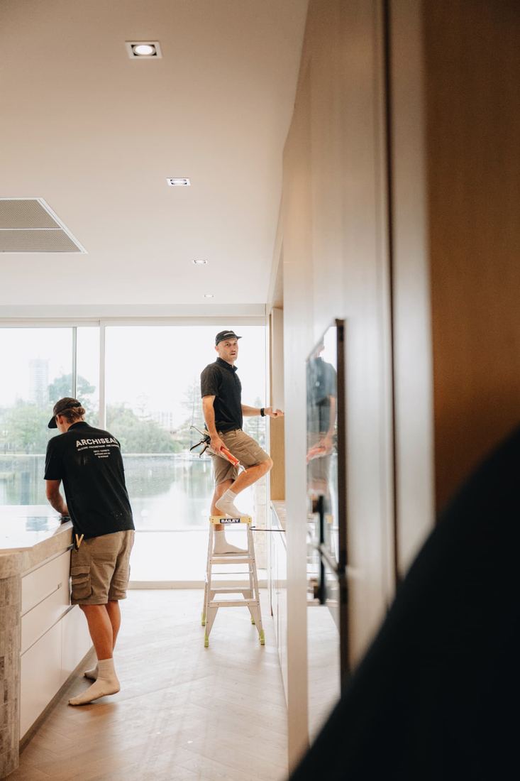 ARCHISEAL crew sealing joinery in a waterfront apartment