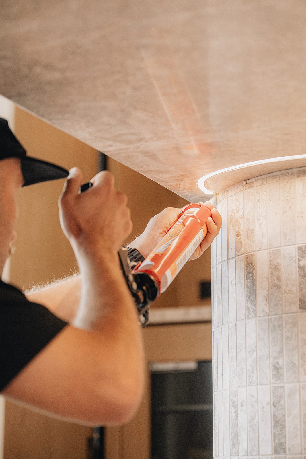 ARCHISEAL technician running a silicone bead with a caulking gun