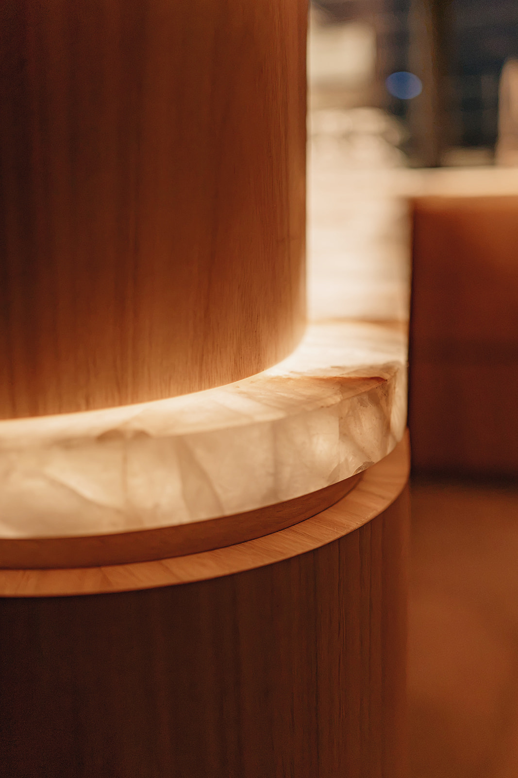 Backlit alabaster and timber joinery detail with a clean sealed joint