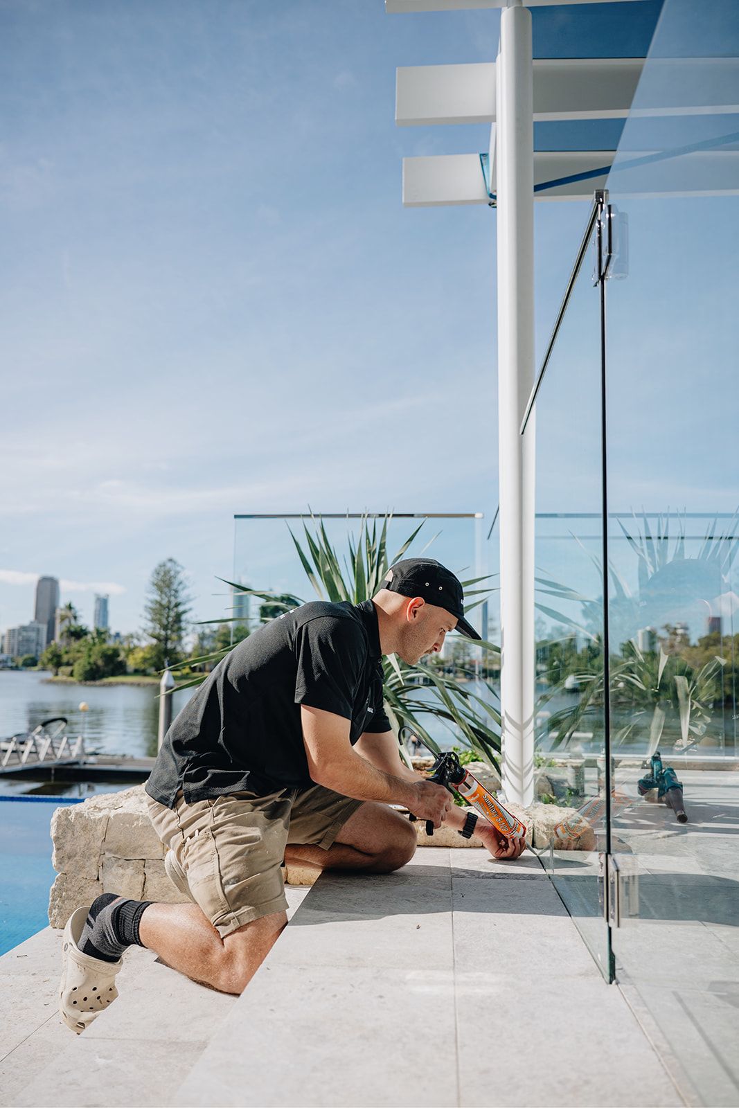 ARCHISEAL applying sealant to a waterfront glass balustrade